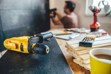 A DIY home renovation in Syracuse, NY gone wrong, with exposed wires, uneven flooring, and frustrated homeowners realizing the challenges of DIY remodeling.