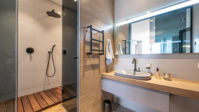Wall-mounted shelves above a toilet in a small bathroom remodel.